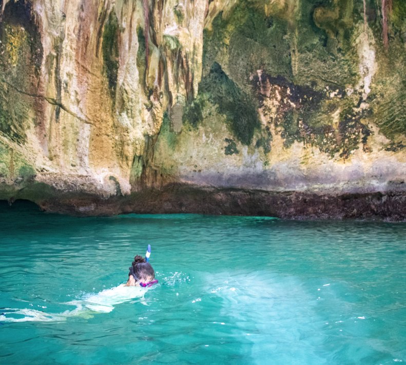 A snorkeler in the shallows above a Bahamian reef